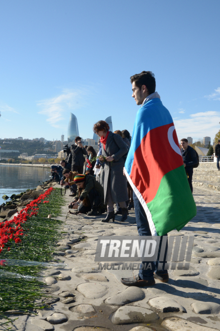 Baku residents bringing flowers to Seaside Boulevard to honor missing oil workers.  Azerbaijan, Dec.07, 2015